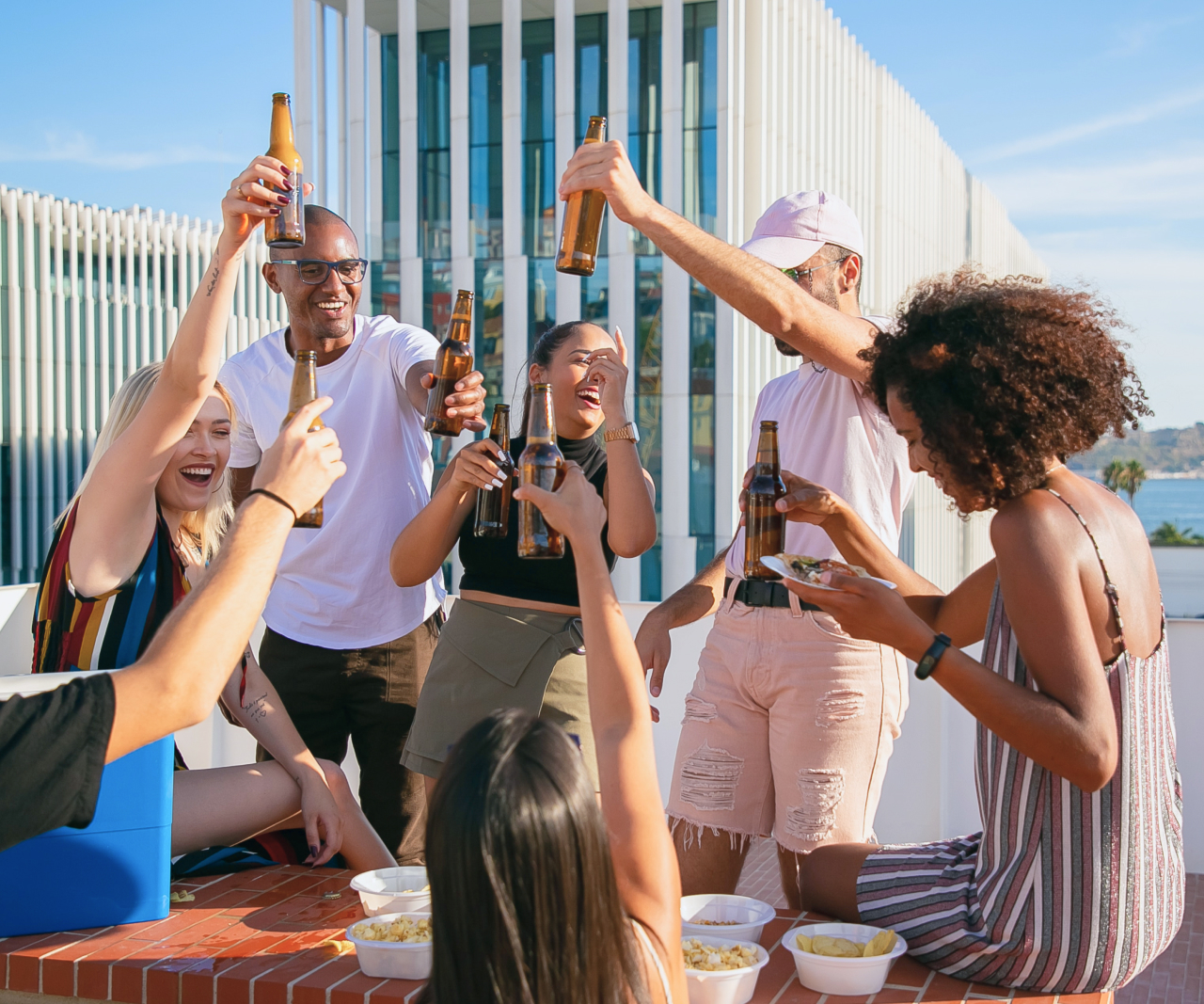 People partying outside and toasting.