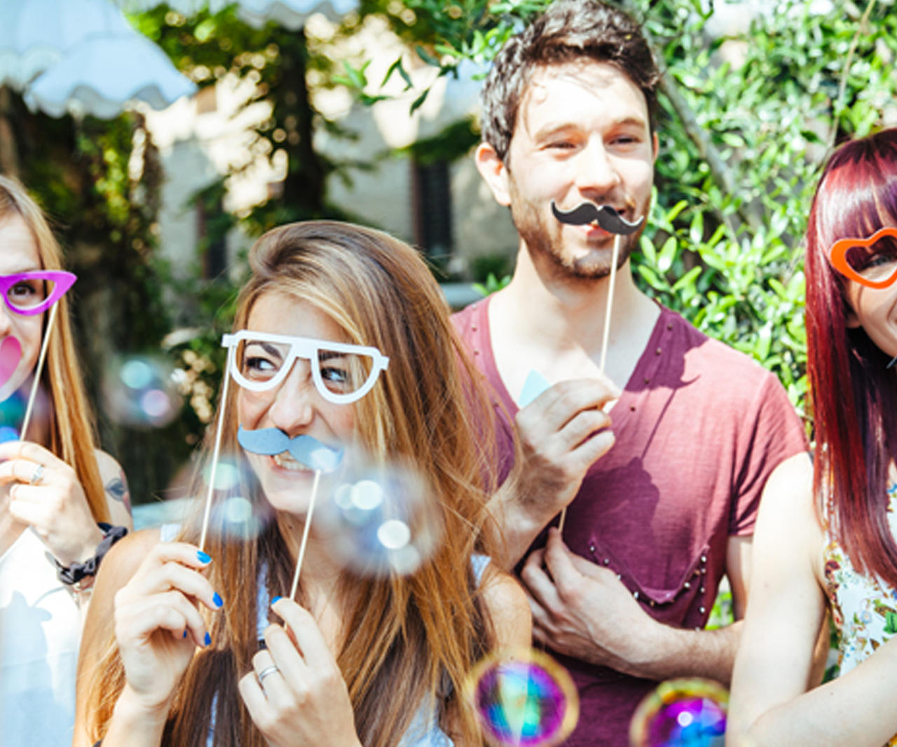 People blowing bubbles outside.