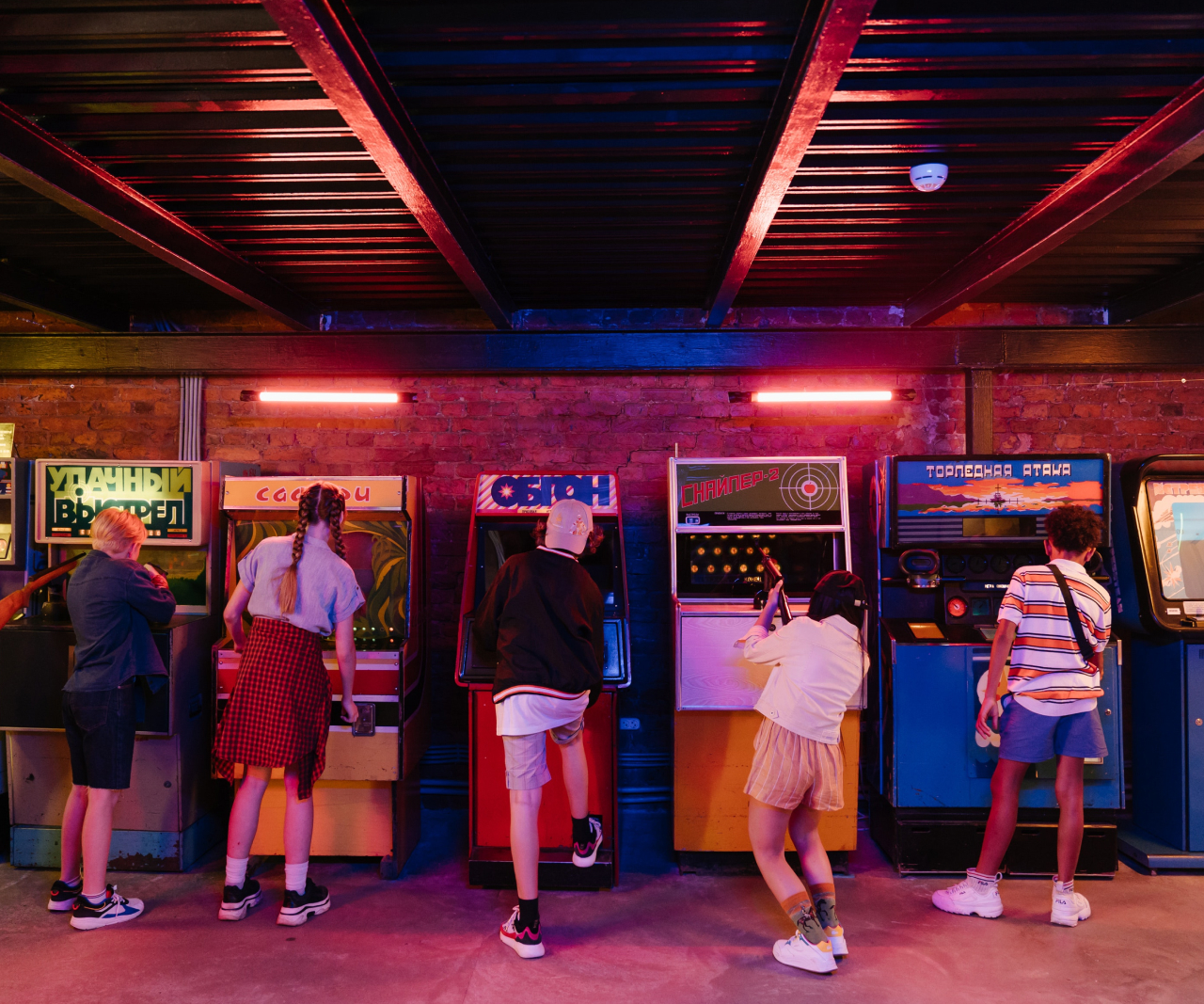 People playing games in an arcade.