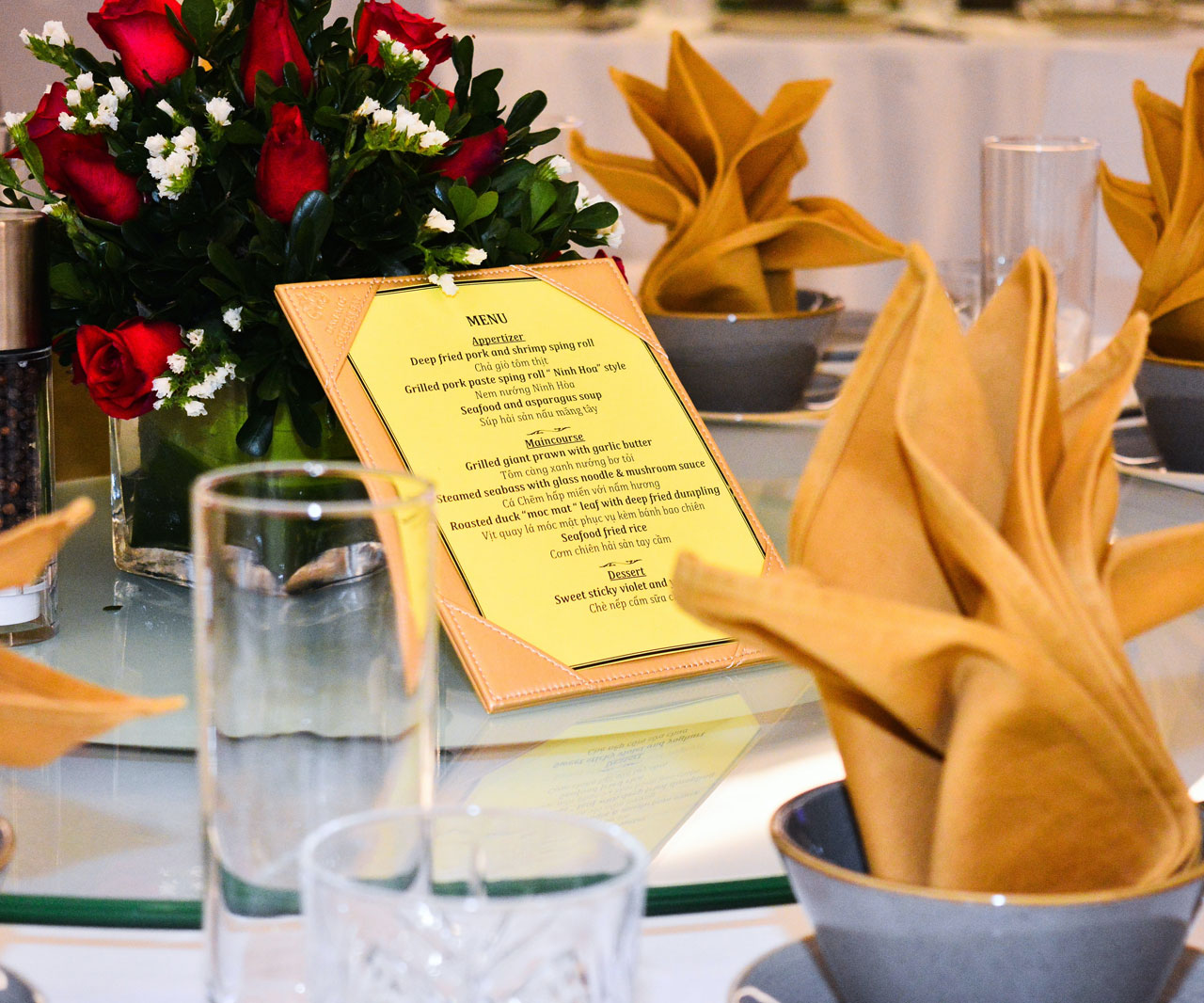 Menu on a table set for a dinner party.