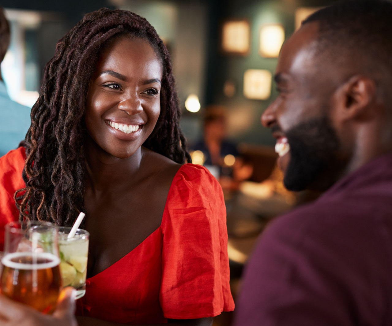 People talking and smiling over drinks.