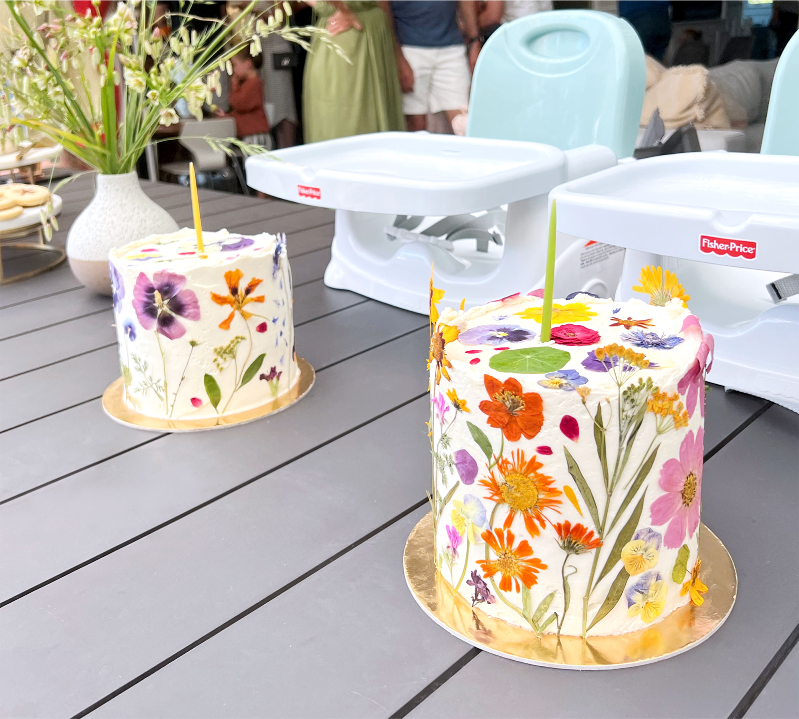 Two cakes covered in flowers.