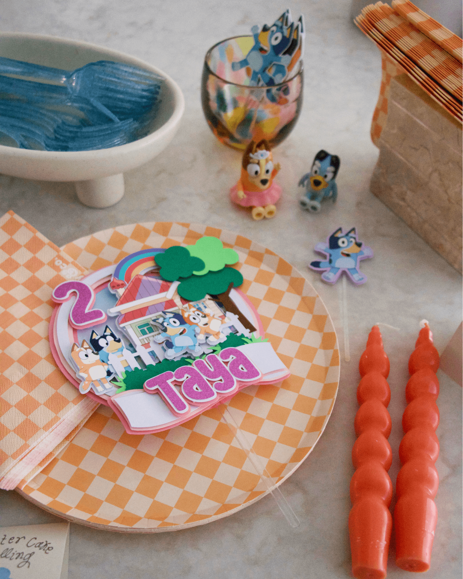 A close-up of the Bluey-themed dinnerware and decor.