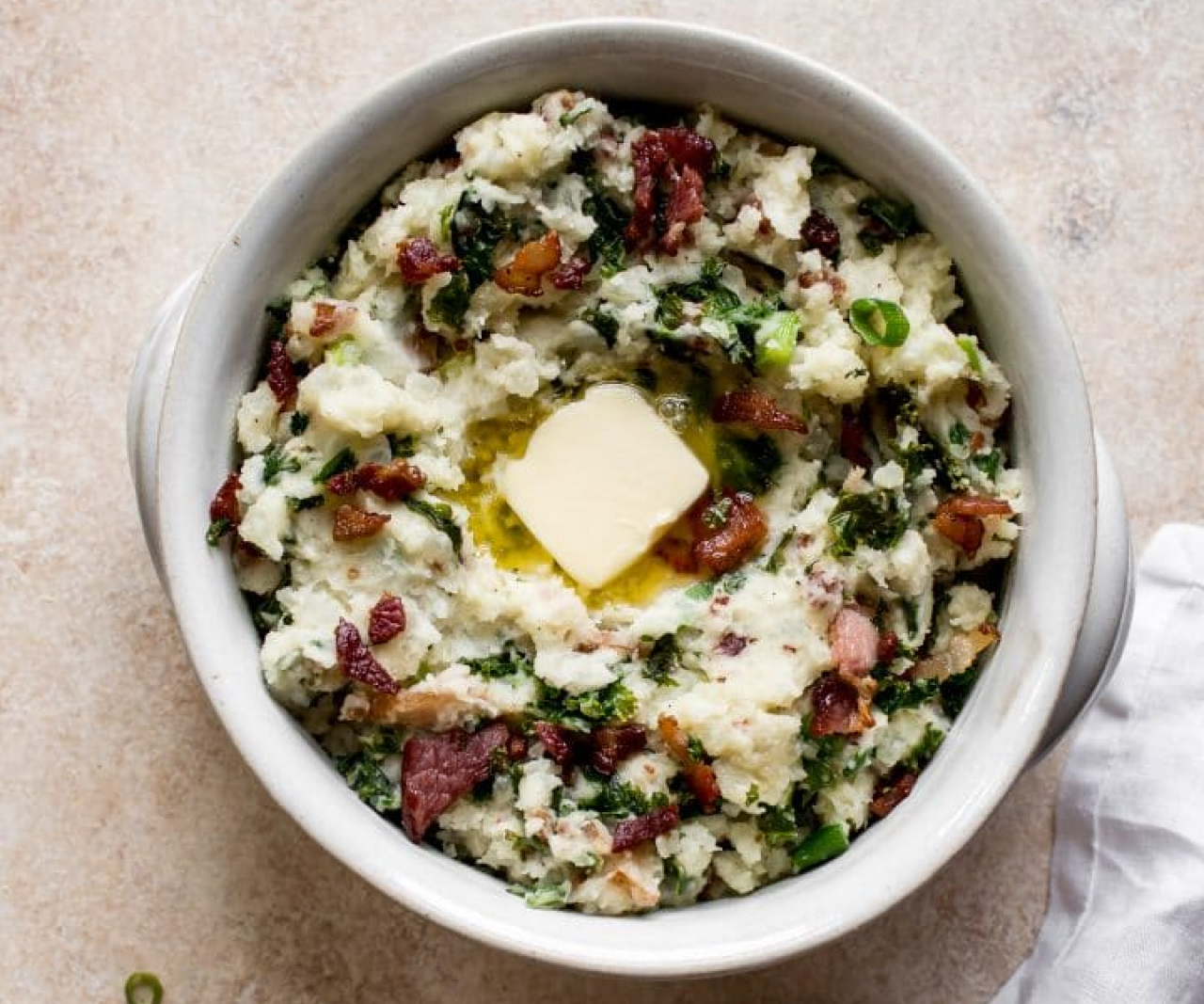 A bowl of colcannon with a square of butter on top.