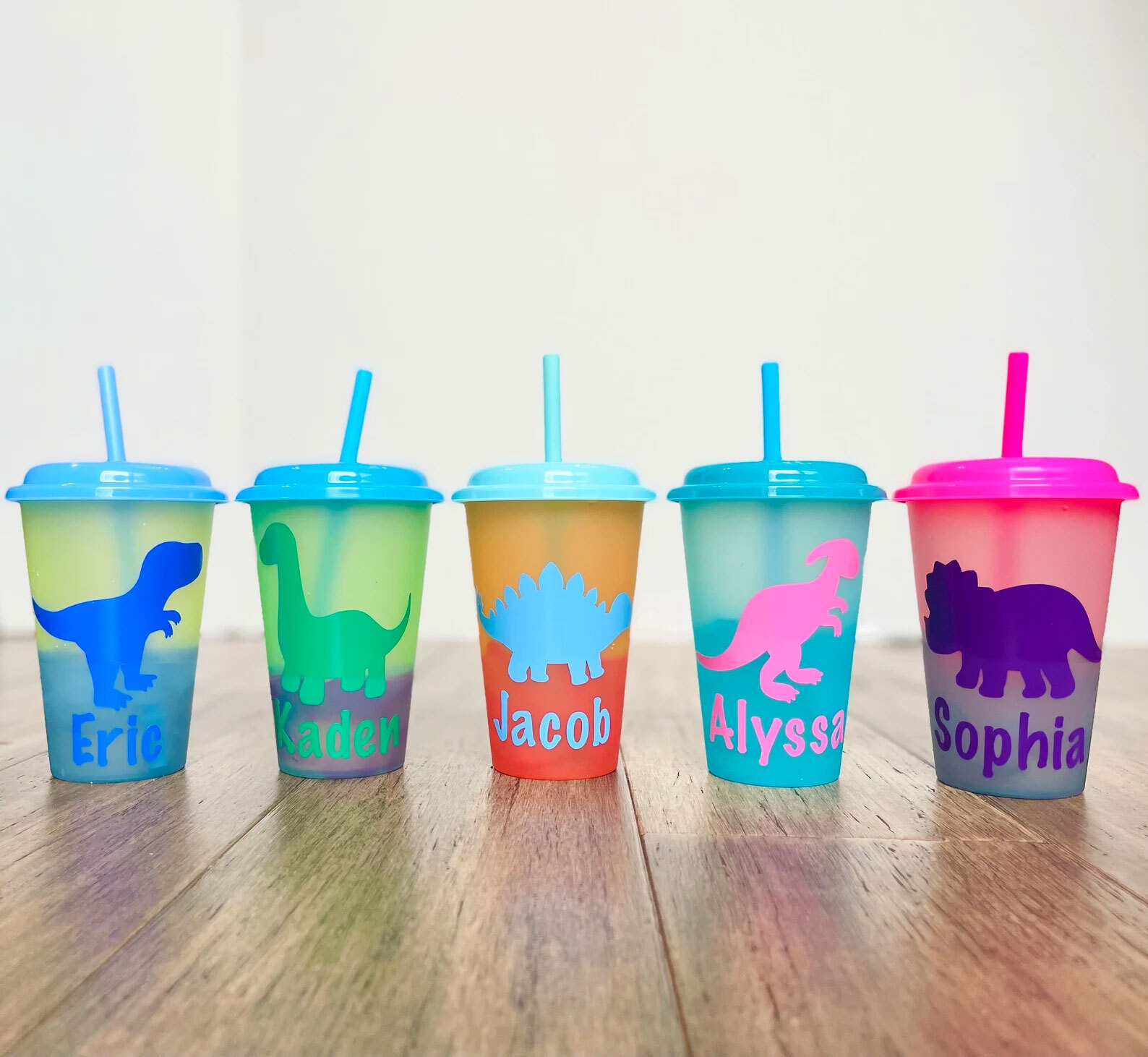 Personalized color-changing dinosaur sippy cups.
