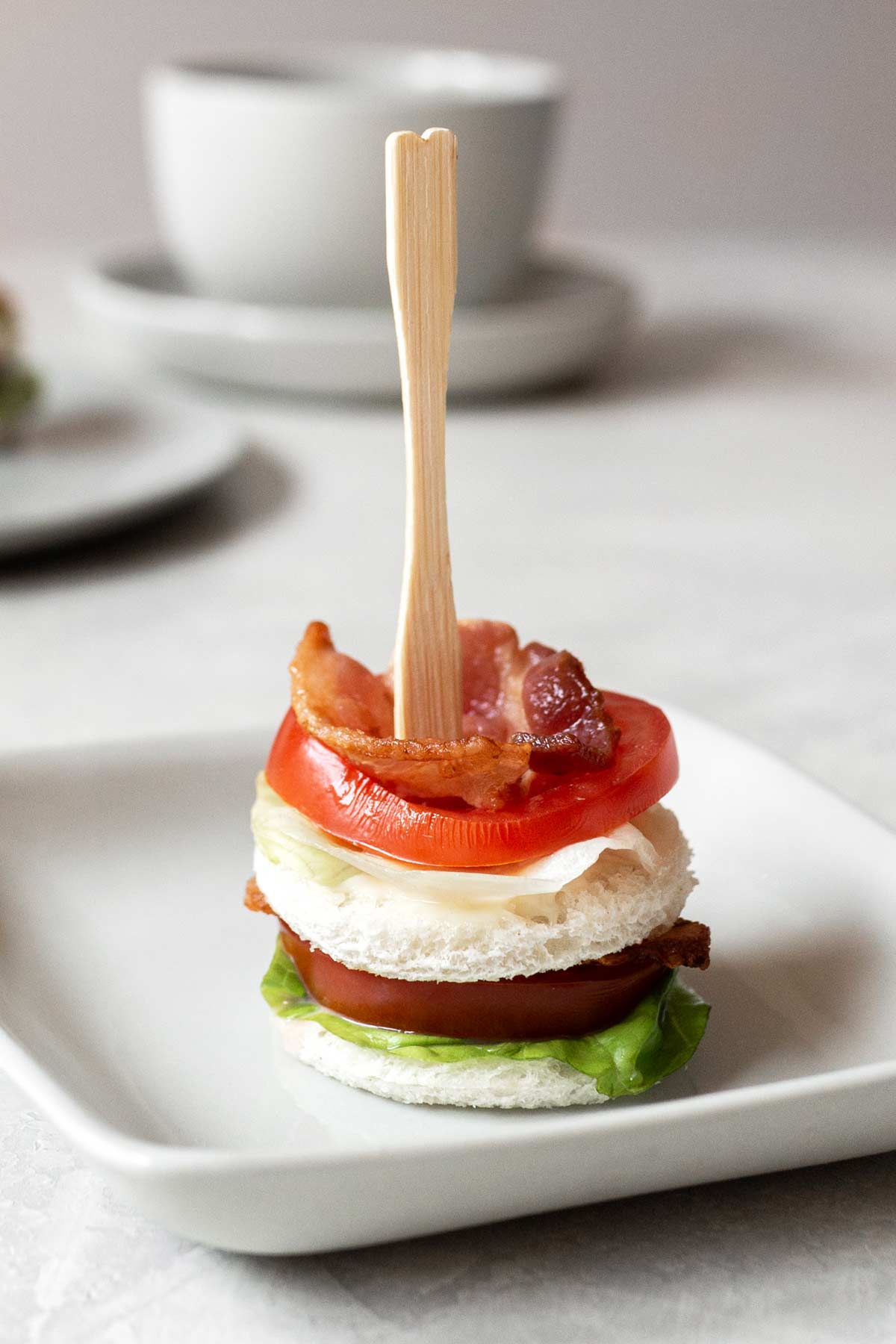 A close-up of a BLT finger sandwich.