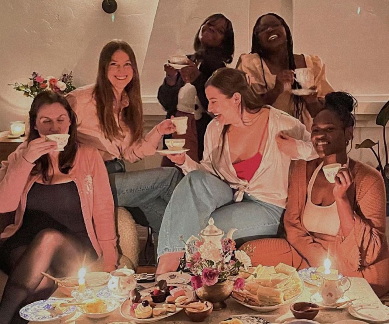 A group of girls at a tea party drinking tea.