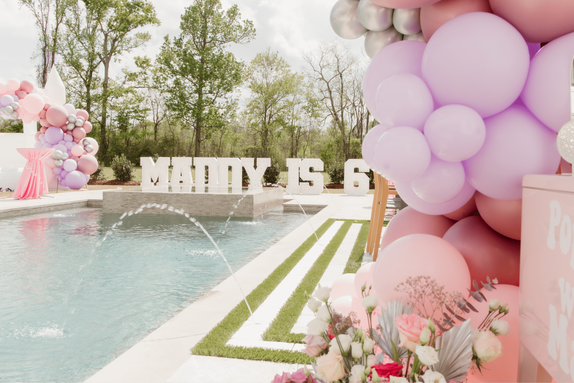 A pool with party decorations surrounding.