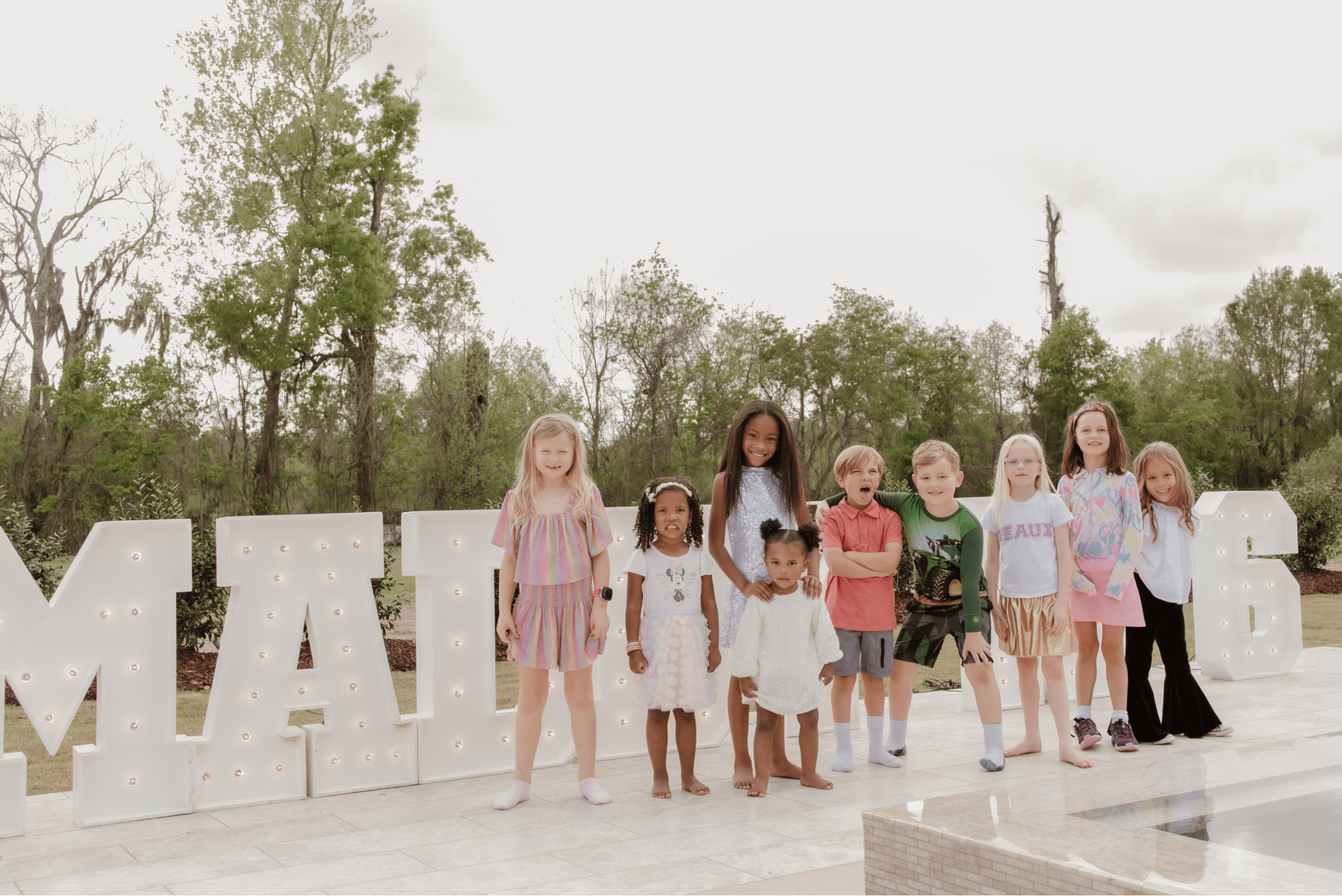 Kids posing with the birthday girl.