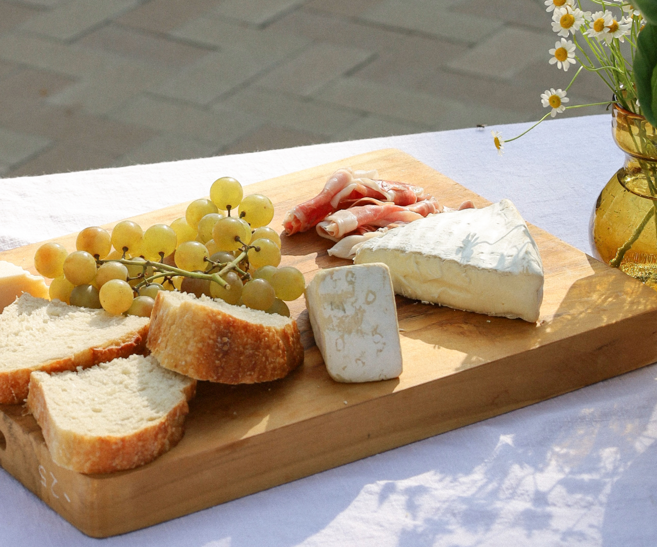 A charcuterie board on a table outside.