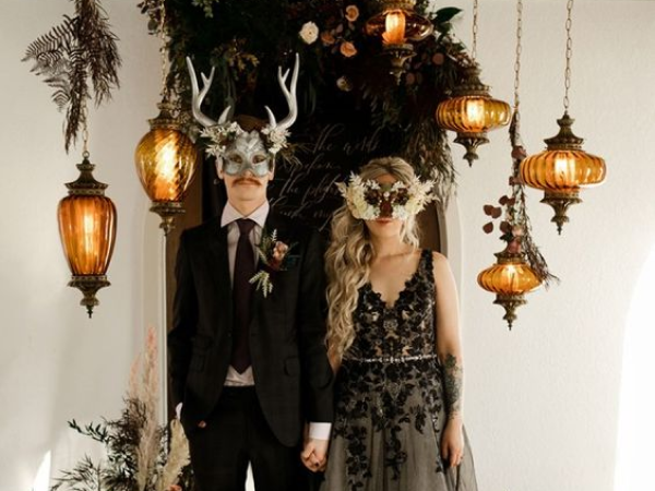 Couple holding hands wearing masks and black wedding attire (image from Pinterest).