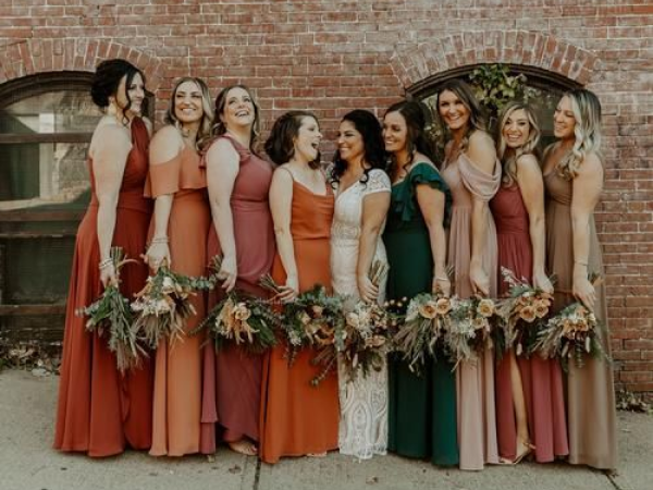 Bridesmaids in a range of fall colors holding bouquets (image from Pinterest).