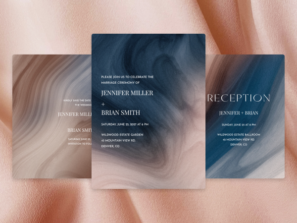 Collection of matching navy and taupe swirl wedding invitations.