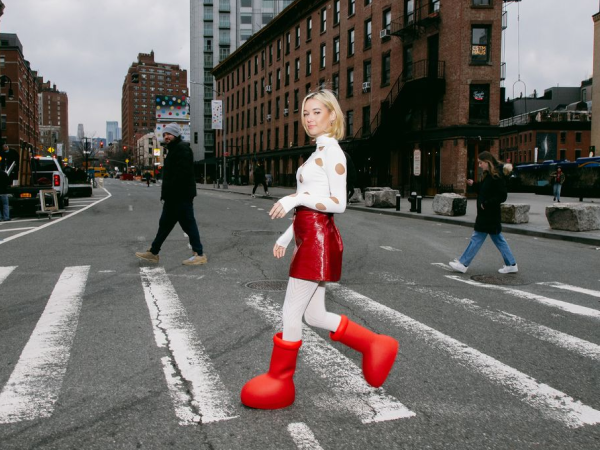 Image of woman crossing the street in big red boots.