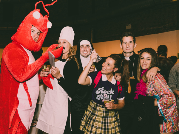 A group of friends at a party in Halloween costumes.