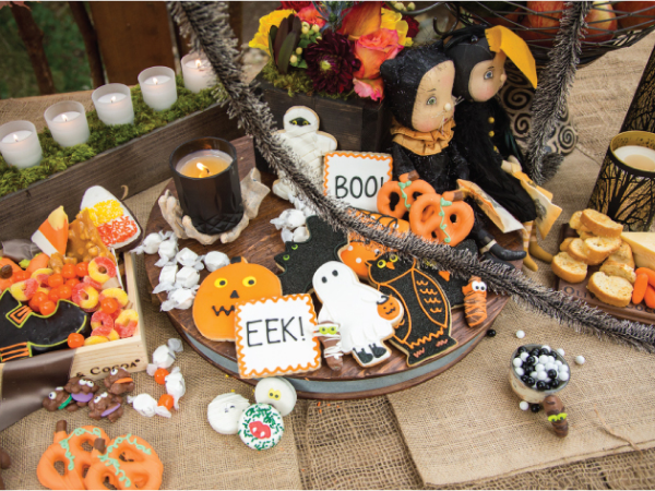 A snack table filled with various Halloween-themed foods.