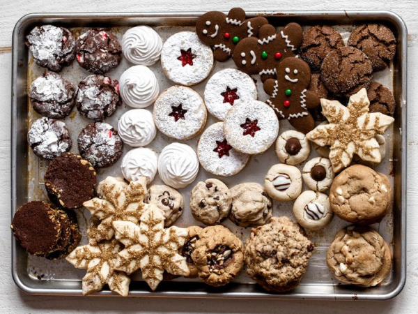 A baking tray full of different kinds of Christmas cookies.