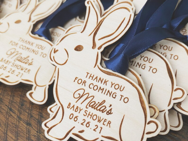 Wooden bunny ornaments with personalized messages.